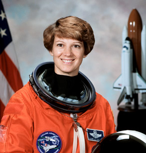 !Eileen Collins floating aboard a spacecraft.