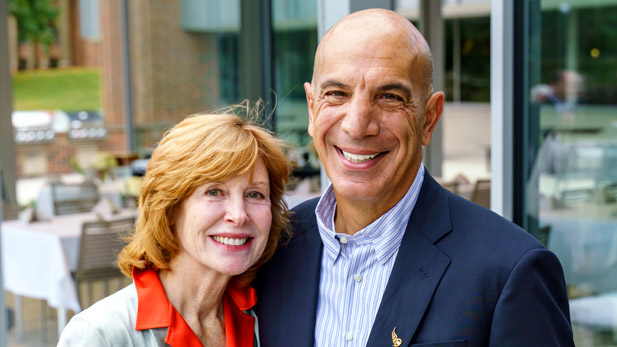 Image shows Linda and Mike Mussallem smiling outside of the Mussallem Union.