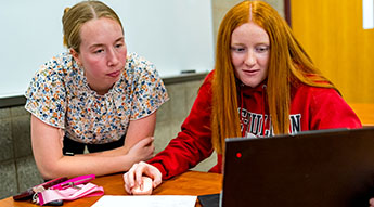 Image of instructor teaching students in classroom.
