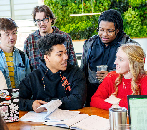 !A group of students around a computer