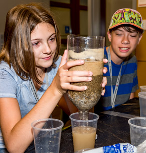Young students doing a hands-on water filtering activity