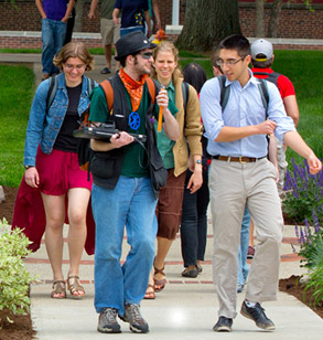 Smiling students walking across campus.