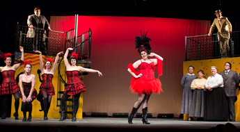 Actors on stage dressed in colorful costumes