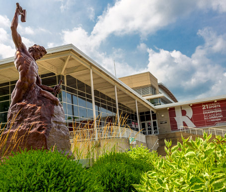 Rose-Hulman Student Recreation Center with Self-made Man sculpture in the foreground and sunny sky in the background.