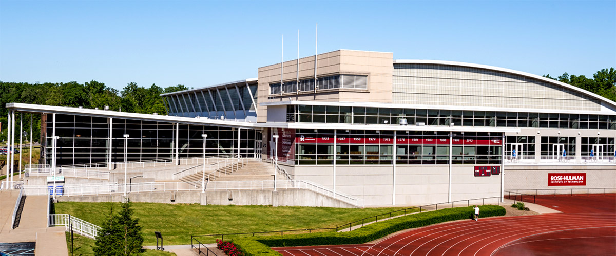 Image shows the southeast side of the Sports and Recreation Center bathed in sunlight and below a clear blue sky.