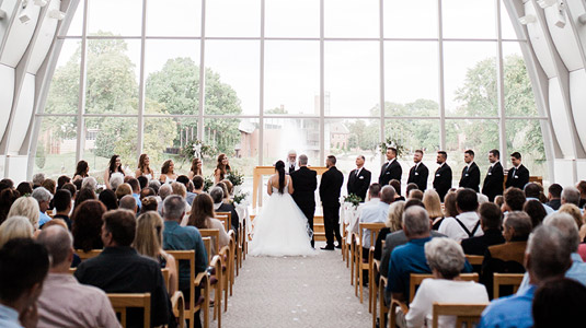 Interior photo of Whit Chapel with wedding party in front of window