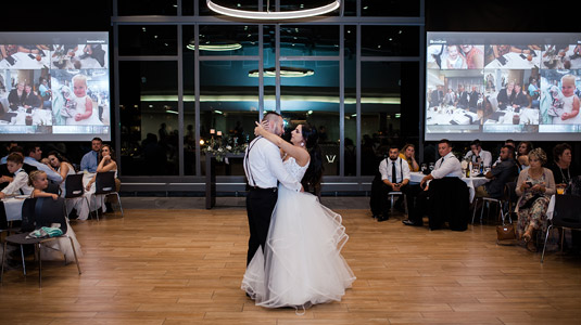 Interior night time photo of bride and groom dancing in the Vonderschmitt