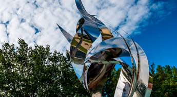 !Flame of the Millennium sculpture against a blue sky.