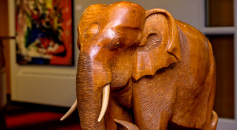 !Carved wooden elephant in the president’s office reception area.