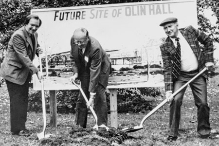 Dr. Sam Hulbert and two other officials participate in a ceremonial groundbreaking for Olin Hall.