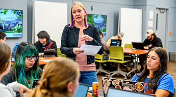 Math faculty and students working in classroom