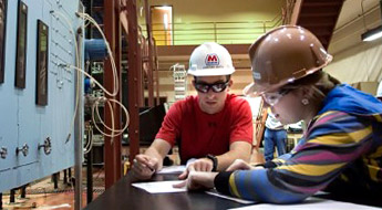 A male student and a female student work in a chemical engineering lab.