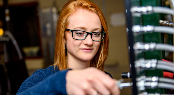 Female student adjusts device.