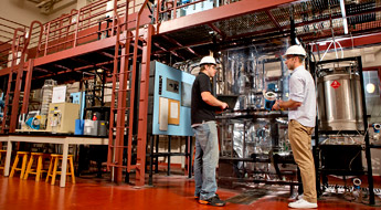 Two male students working in High Bay Lab.