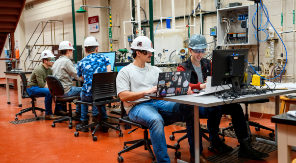 Male students work in a lab. 