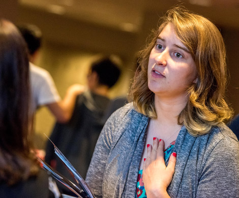 Female student talking with a recruiter at a Graduate School Fair. 