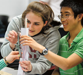 Students working together on a project in a classroom.