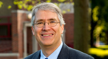 !A smiling Dr. Phil Cornwell standing outdoors at Rose-Hulman