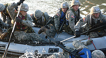 Group of individuals in uniform surround a boat in water.