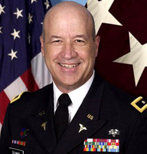 Close-up headshot of James K. Gilman in uniform with American flag in the background.