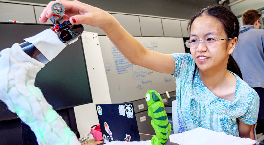 Students demonstrate specialized toy for developing motorskills