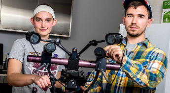 Two students conduct research inside a biomedical engineering laboratory. 