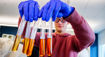 Male student works with test tubes for an experiment.