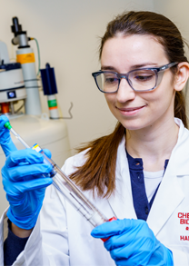 Female student prepares DNA samples for testing.