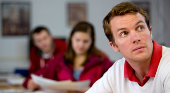 A male student in a classroom