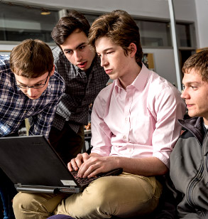 Cyber Defense team members working together during an intense competition.