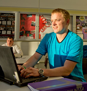 Student working on a laptop in a computer lab.