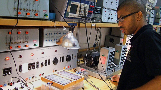 Male student works in electrical lab.