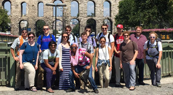 Rose-Hulman study abroad group posing outside the coliseum in Rome.