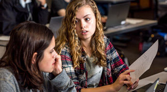 Two students discussing a math problem.