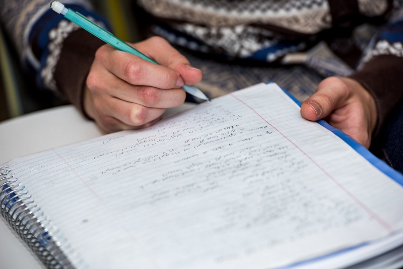 A student's notebook with math equations.