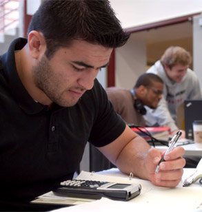 A student using a calculator to solve a statistics problem.