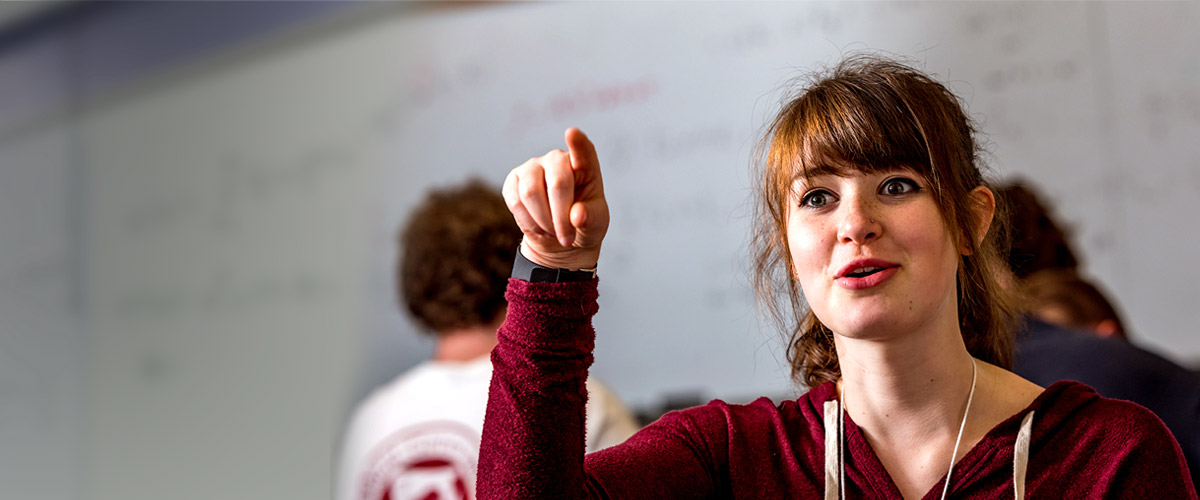 Student gesturing in a mathematics classroom.