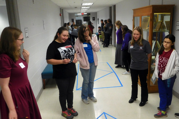 Students doing math activities in hallway
