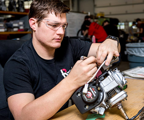 Male student working on small engine