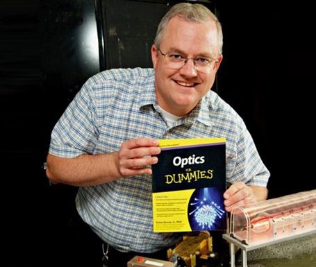 Dr. Duree poses with his book Optics for Dummies.