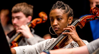 Female student playing a cello.