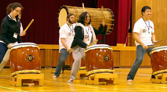 Students play ethnic drums.