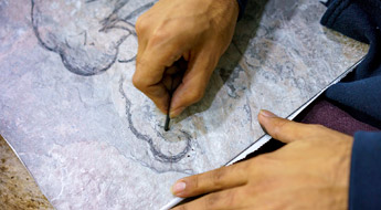 Man instructs student who is sketching a landscape.
