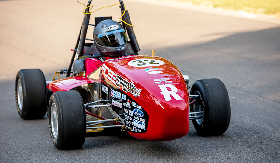 Student racing in car on track