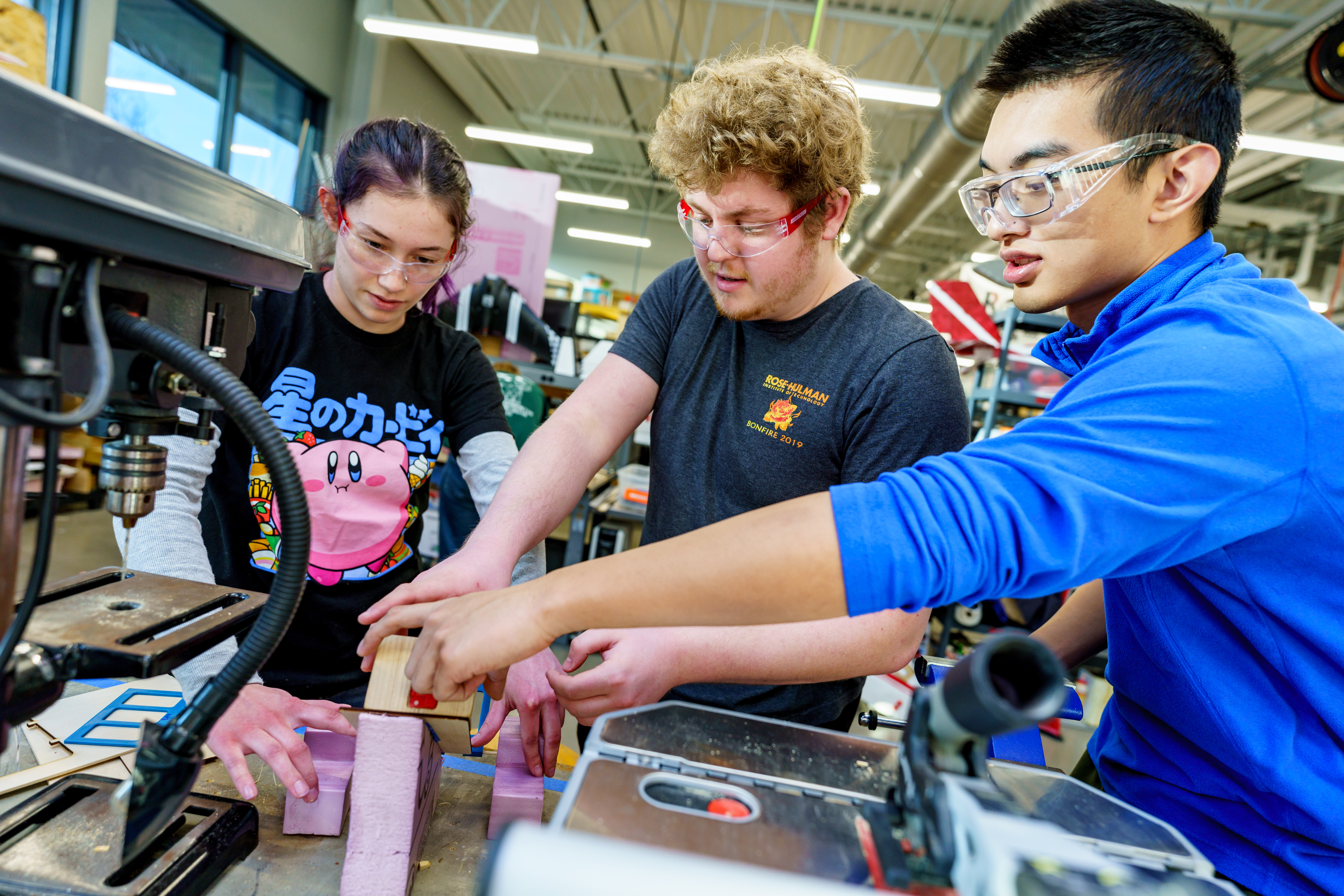 Three students work on equipment in the BIC.