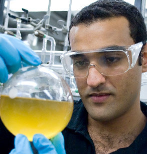 Student looking at fluid in beaker