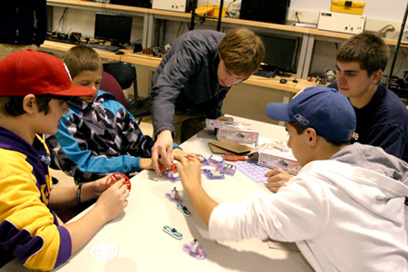 Rose-Hulman students working with younger students to build a hands-on project.
