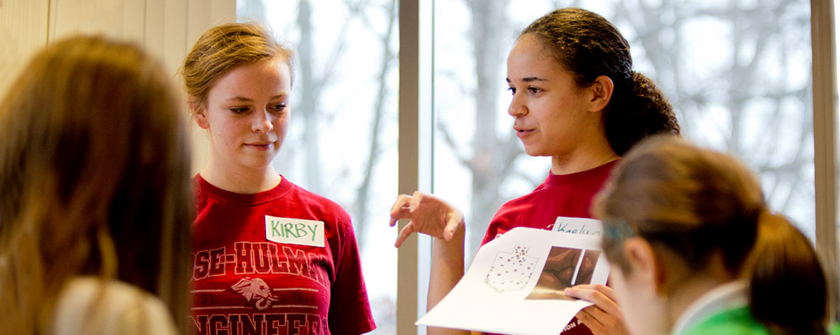 Female student explains Grand Challenges activity. 