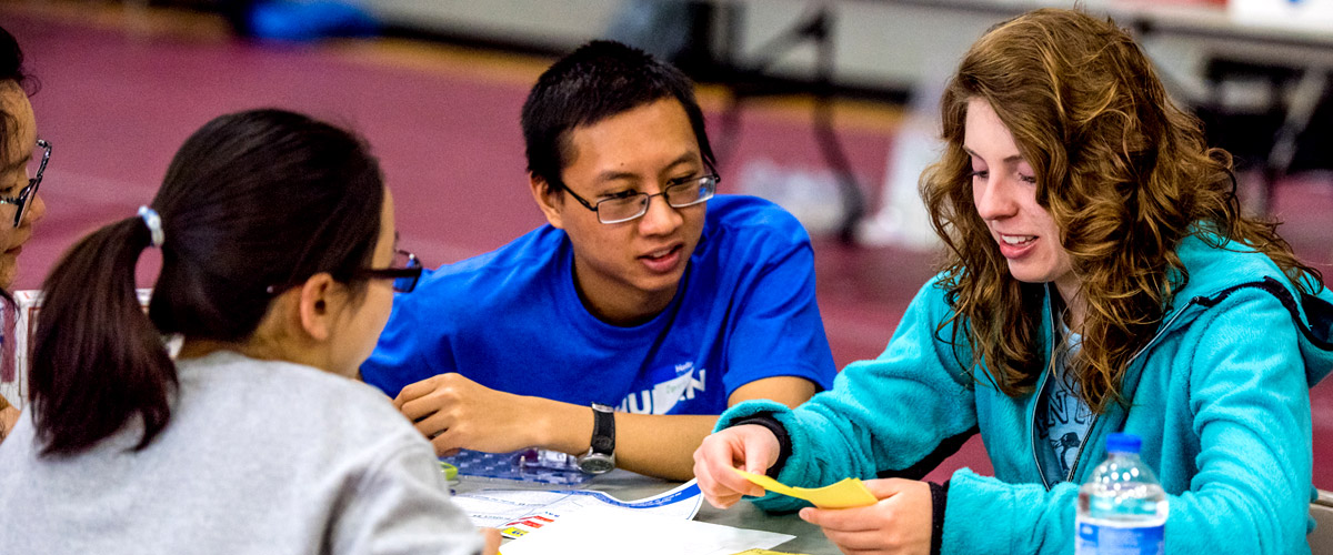 A group of students work together on a hands-on project during the SPARK competition.