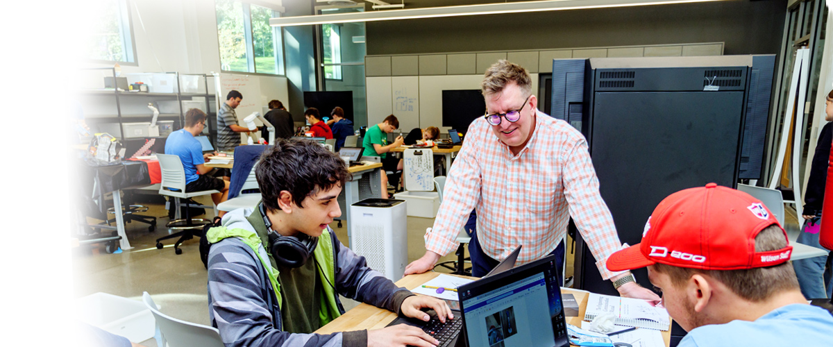 Student and faculty working in class.